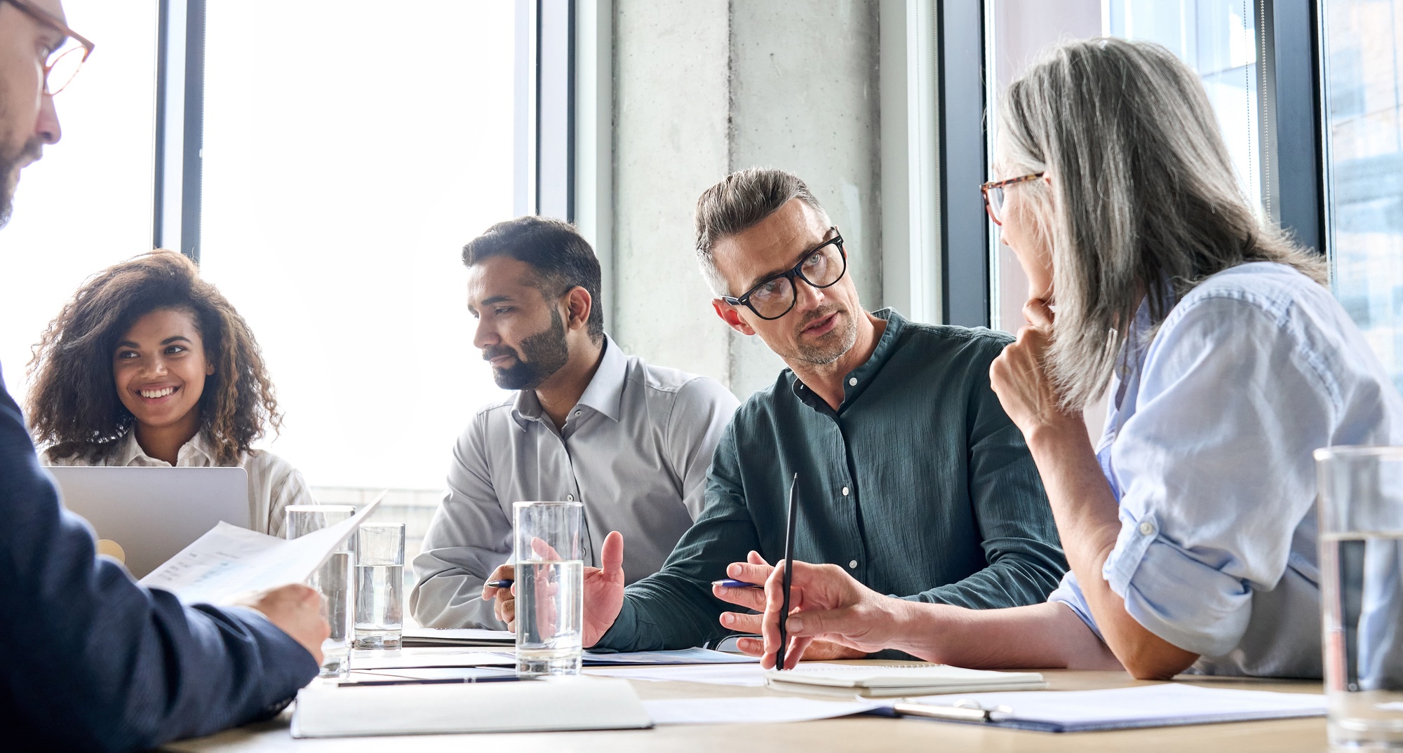 Diverse businesspeople executive team negotiating at boardroom meeting.